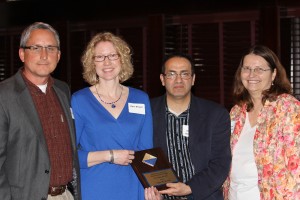 Joyce Brown (in blue) receives the Outstanding High School Chemistry Teacher Award from Ziad Ramadan and Sandi Mueller while her spouse beams